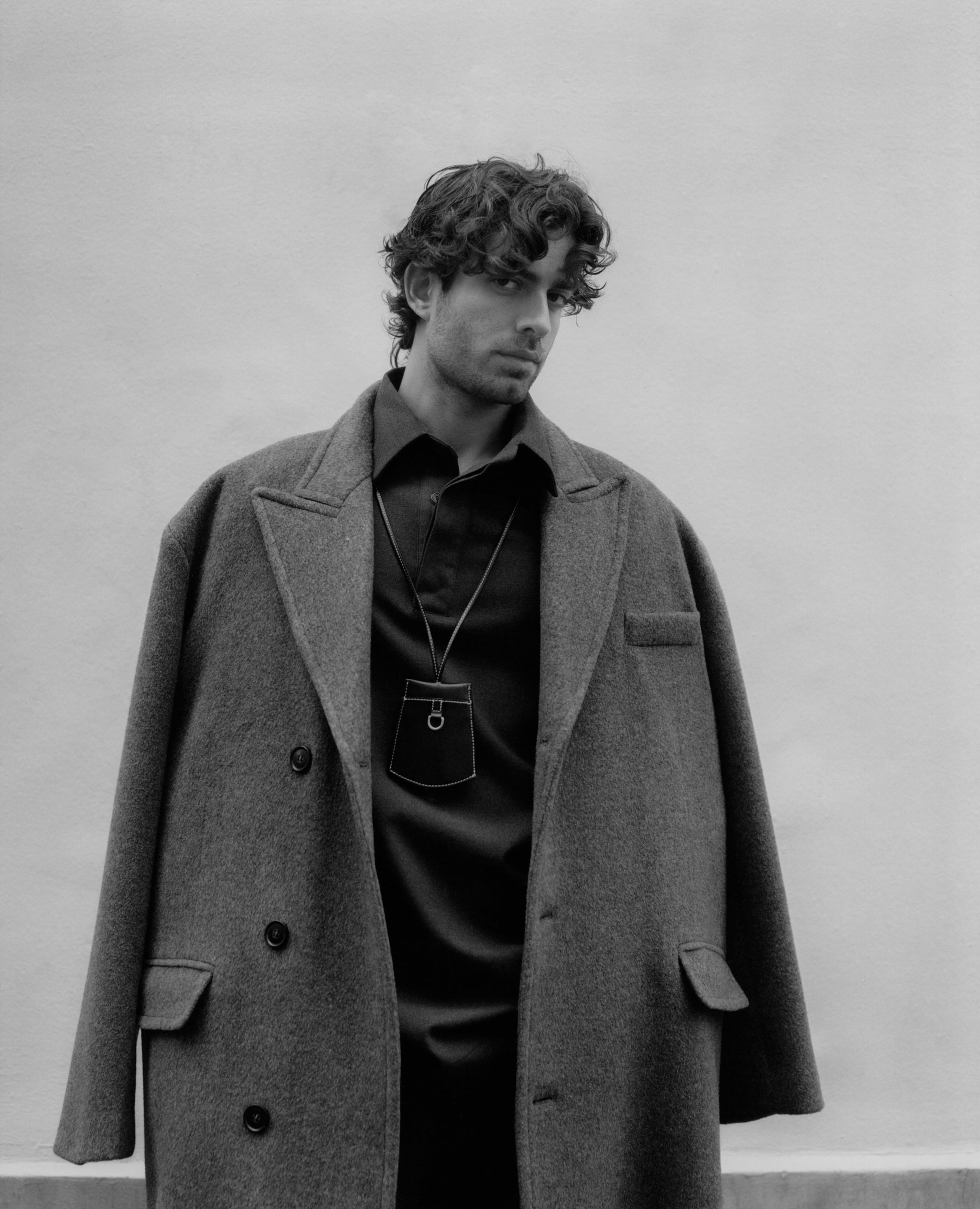 Males model photographed by Deon Hinton wearing The Frankie Shop coat. 